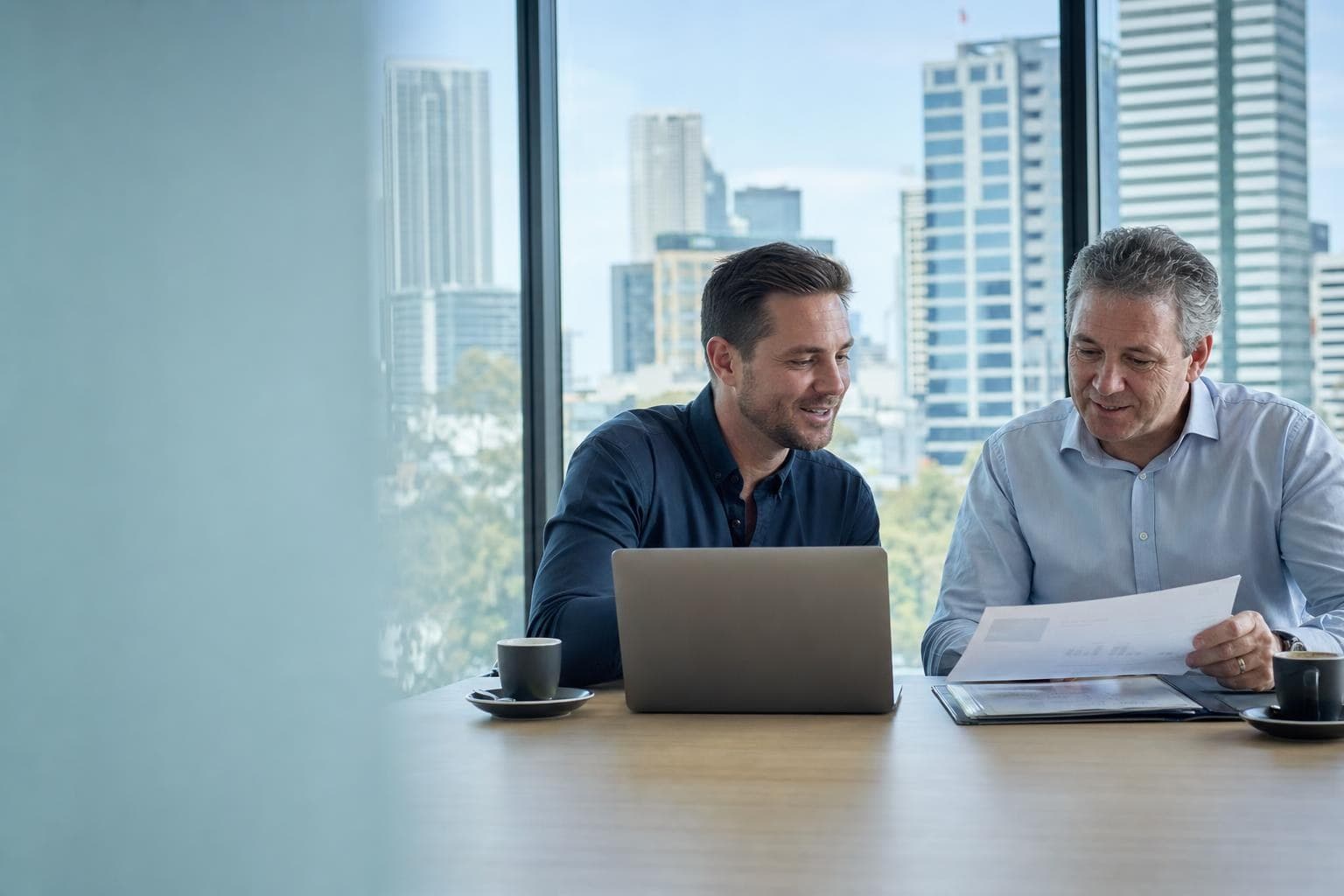 A Lyft Money broker and a referral partner reviewing a client proposal together
